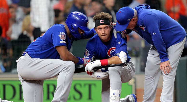 Cubs center fielder Albert Almora Jr. (5, center) is consoled by right fielder Jason Heyward (22, left) and manager Joe Maddon (70) after a fan was hit by a foul ball of his. Cubs center fielder Albert Almora Jr. (5, center) is consoled by right fielder Jason Heyward (22, left) and manager Joe Maddon (70) after a fan was hit by a foul ball of his.