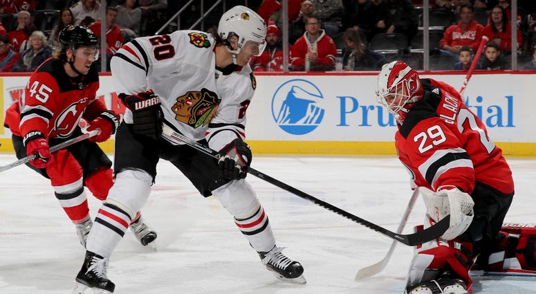 Blackhawks forward Brandon Saad (20) attempts to shoot the puck by Devils goalie Mackenzie Blackwood (29). Blackhawks forward Brandon Saad (20) attempts to shoot the puck by Devils goalie Mackenzie Blackwood (29).