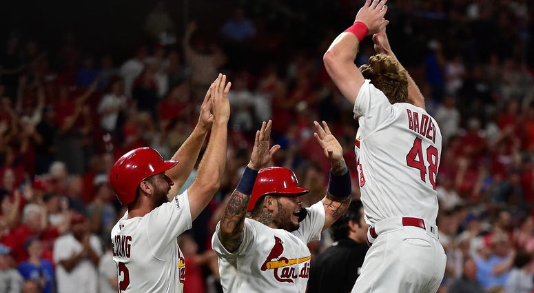 Cardinals center fielder Harrison Bader (48) celebrates with catcher Yadier Molina (4) and shortstop Paul DeJong (12). Cardinals center fielder Harrison Bader (48) celebrates with catcher Yadier Molina (4) and shortstop Paul DeJong (12).