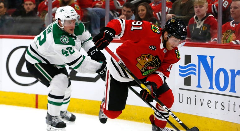 Blackhawks center Drake Caggiula (91) controls the puck in front of Stars defenseman Taylor Fedun (42). Blackhawks center Drake Caggiula (91) controls the puck in front of Stars defenseman Taylor Fedun (42).