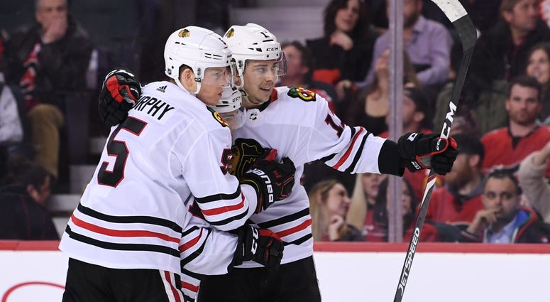 Blackhawks center Dylan Strome (17) celebrates a goal against the Flames. Blackhawks center Dylan Strome (17) celebrates a goal against the Flames.