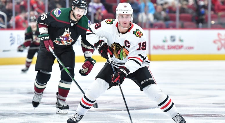 Blackhawks center Jonathan Toews (19) carries the puck as Coyotes center Brad Richardson (15) defends. Blackhawks center Jonathan Toews (19) carries the puck as Coyotes center Brad Richardson (15) defends.