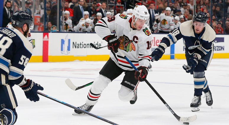Blackhawks center Jonathan Toews (19) skates past Blue Jackets defenseman David Savard (58). Blackhawks center Jonathan Toews (19) skates past Blue Jackets defenseman David Savard (58).