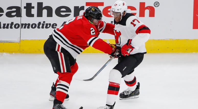 lackhawks defenseman Duncan Keith (2) battles for the puck with Devils right wing Wayne Simmonds (17). lackhawks defenseman Duncan Keith (2) battles for the puck with Devils right wing Wayne Simmonds (17).