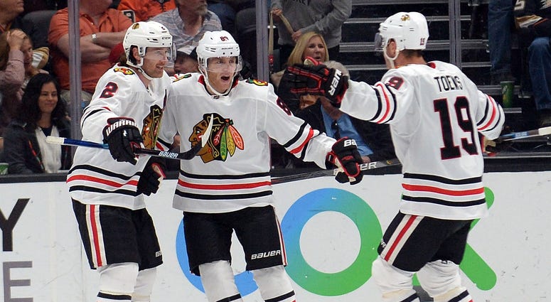 Blackhawks right wing Patrick Kane (88) celebrates his overtime goal against the Ducks with defenseman Duncan Keith (2) and center Jonathan Toews (19). Blackhawks right wing Patrick Kane (88) celebrates his overtime goal against the Ducks with defenseman Duncan Keith (2) and center Jonathan Toews (19).