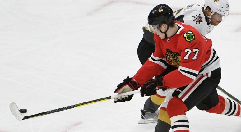 Blackhawks center Kirby Dach (77) tries to get past Golden Knights defenseman Jon Merrill (15). Blackhawks center Kirby Dach (77) tries to get past Golden Knights defenseman Jon Merrill (15).