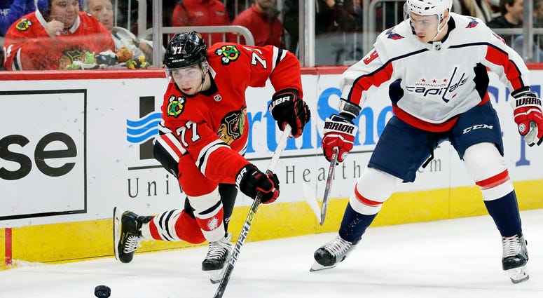 Blackhawks rookie forward Kirby Dach (77) and Capitals defenseman Dmitry Orlov (9) battle for the puck. Blackhawks rookie forward Kirby Dach (77) and Capitals defenseman Dmitry Orlov (9) battle for the puck.
