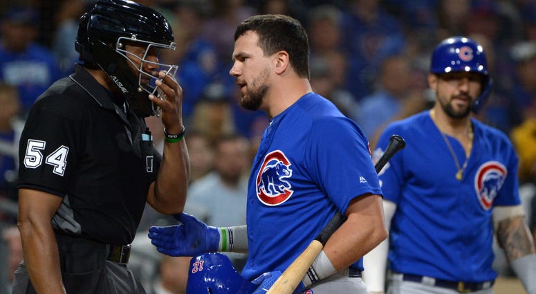 Cubs left fielder Kyle Schwarber (middle) talks to umpire CB Bucknor (54) after being called out on strikes. Cubs left fielder Kyle Schwarber (middle) talks to umpire CB Bucknor (54) after being called out on strikes.