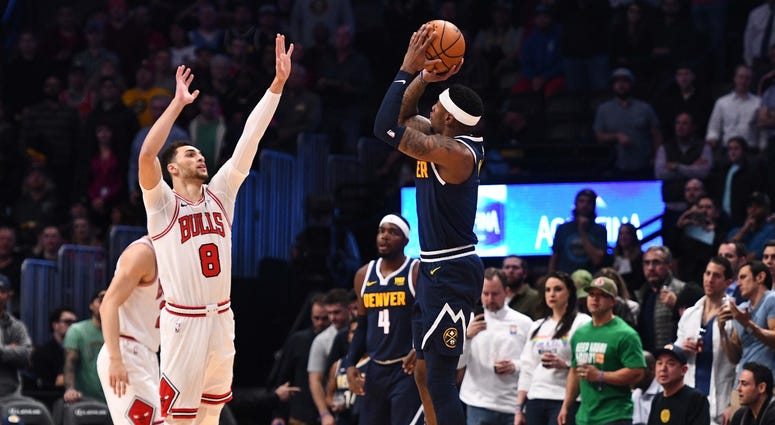 Nuggets forward Torrey Craig (3) attempts a 3-pointer over Bulls guard Zach LaVine (8). Nuggets forward Torrey Craig (3) attempts a 3-pointer over Bulls guard Zach LaVine (8).