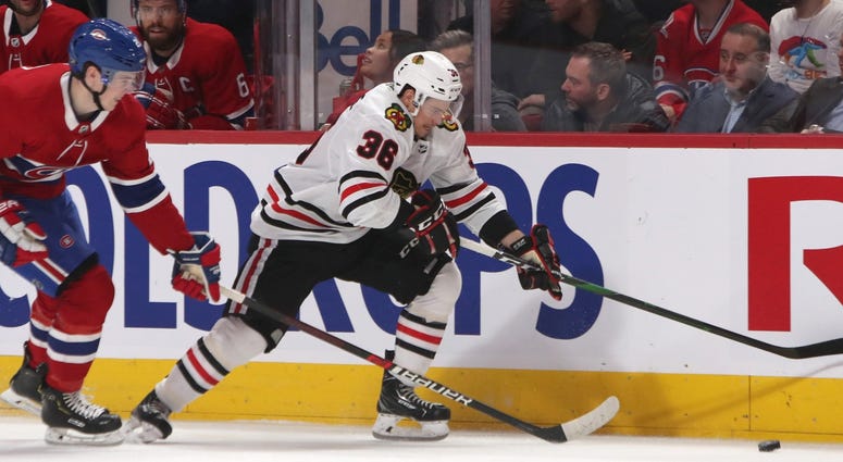 Blackhawks center Matthew Highmore (36) plays the puck against Canadiens defenseman Cale Fleury (20). Blackhawks center Matthew Highmore (36) plays the puck against Canadiens defenseman Cale Fleury (20).