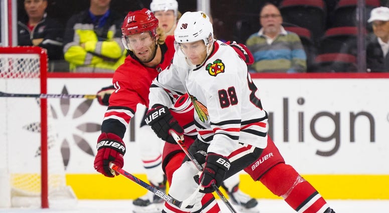Blackhawks right wing Patrick Kane (88) skates with the puck against Hurricanes center Jordan Staal (11). Blackhawks right wing Patrick Kane (88) skates with the puck against Hurricanes center Jordan Staal (11).