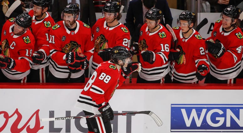 Blackhawks winger Patrick Kane (88) celebrates with teammates after scoring against the Blues. Blackhawks winger Patrick Kane (88) celebrates with teammates after scoring against the Blues.
