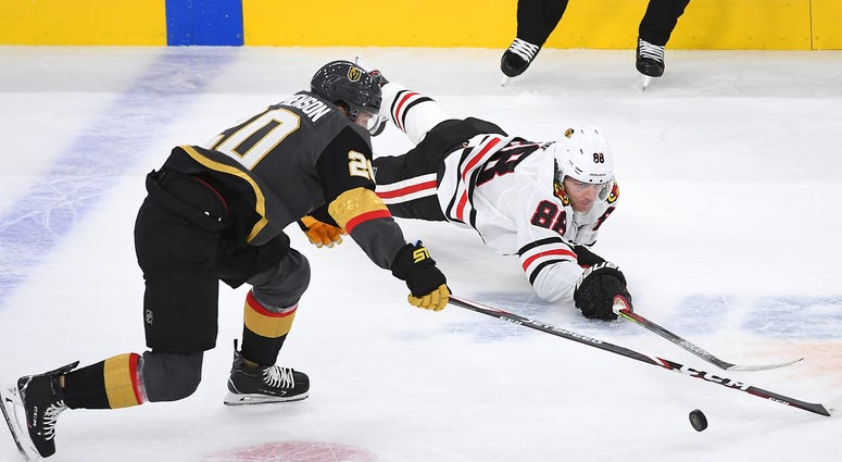 Blackhawks right wing Patrick Kane (88) tips the puck away from Golden Knights center Chandler Stephenson (20). Blackhawks right wing Patrick Kane (88) tips the puck away from Golden Knights center Chandler Stephenson (20).