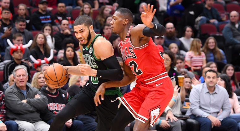 Celtics forward Jayson Tatum (0) drives against Bulls guard Kris Dunn (32). Celtics forward Jayson Tatum (0) drives against Bulls guard Kris Dunn (32).