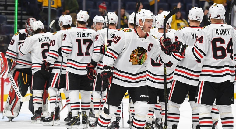 Blackhawks center Jonathan Toews (19) celebrates with teammates after a win against the Predators. Blackhawks center Jonathan Toews (19) celebrates with teammates after a win against the Predators.