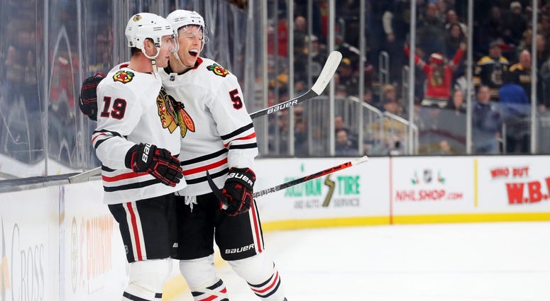 Blackhawks forward Jonathan Toews (19) and defenseman Connor Murphy (5) celebrate Toews' game-winning goal against the Bruins. Blackhawks forward Jonathan Toews (19) and defenseman Connor Murphy (5) celebrate Toews' game-winning goal against the Bruins.