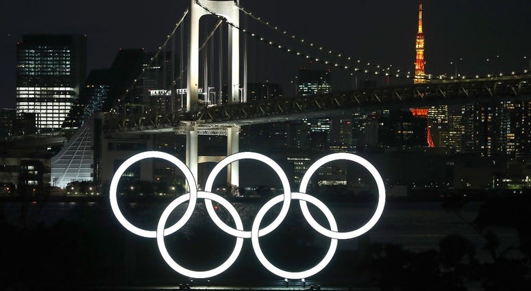 The sun sets behind the Olympic rings at Odaiba Marine Park on March 18, 2020 in Tokyo, Japan. The sun sets behind the Olympic rings at Odaiba Marine Park on March 18, 2020 in Tokyo, Japan.