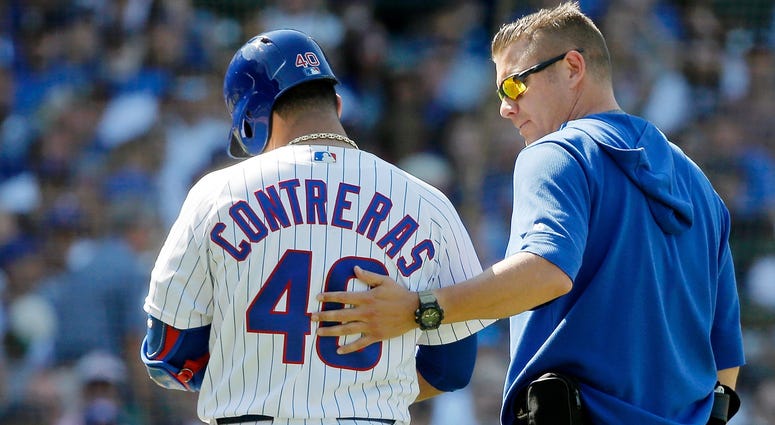 Cubs catcher Willson Contreras (40) walks off the field with head trainer PJ Mainville after suffering a hamstring injury. Cubs catcher Willson Contreras (40) walks off the field with head trainer PJ Mainville after suffering a hamstring injury.