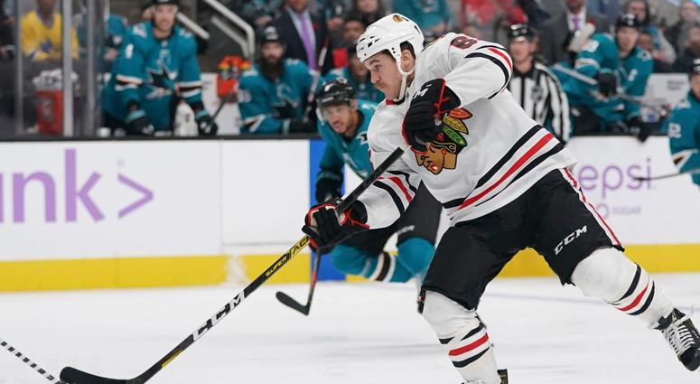 Blackhawks center Andrew Shaw (65) shoots the puck against the Sharks. Blackhawks center Andrew Shaw (65) shoots the puck against the Sharks.