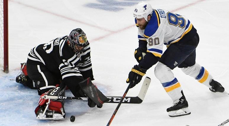 Blackhawks goaltender Corey Crawford (50) makes a save on Blues center Ryan O'Reilly (90). Blackhawks goaltender Corey Crawford (50) makes a save on Blues center Ryan O'Reilly (90).