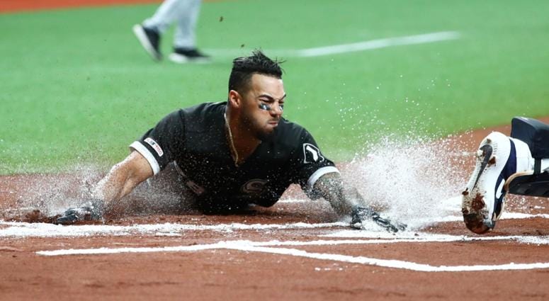 White Sox outfielder Leury Garcia (28) slides safe into home plate. White Sox outfielder Leury Garcia (28) slides safe into home plate.