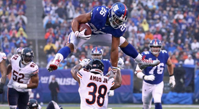 Giants running back Saquon Barkley leaps over Bears safety Adrian Amos for extra yards. Giants running back Saquon Barkley leaps over Bears safety Adrian Amos for extra yards.