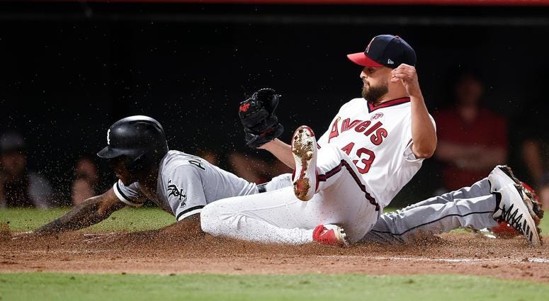 White Sox shortstop Tim Anderson (back) dives to score past Angels starting pitcher Patrick Sandoval (43) on a wild pitch. White Sox shortstop Tim Anderson (back) dives to score past Angels starting pitcher Patrick Sandoval (43) on a wild pitch.