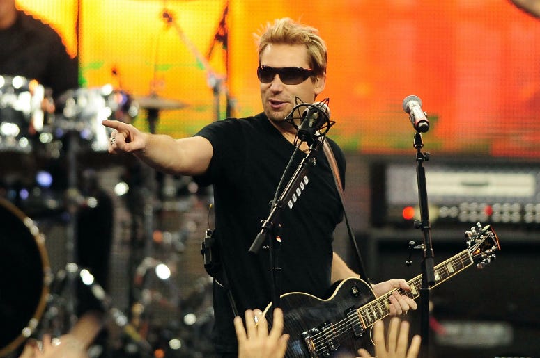 Nickelback recording artist Chad Kroeger performs during halftime of the Thanksgiving game between the Detroit Lions and the Green Bay Packers at Ford Field. Nickelback recording artist Chad Kroeger performs during halftime of the Thanksgiving game between the Detroit Lions and the Green Bay Packers at Ford Field.