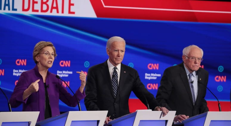 Sen. Elizabeth Warren (D-MA) speaks as former Vice President Joe Biden and Sen. Bernie Sanders (I-VT) (R) listen during the Democratic presidential primary debate at Drake University on January 14, 2020 in Des Moines, Iowa.