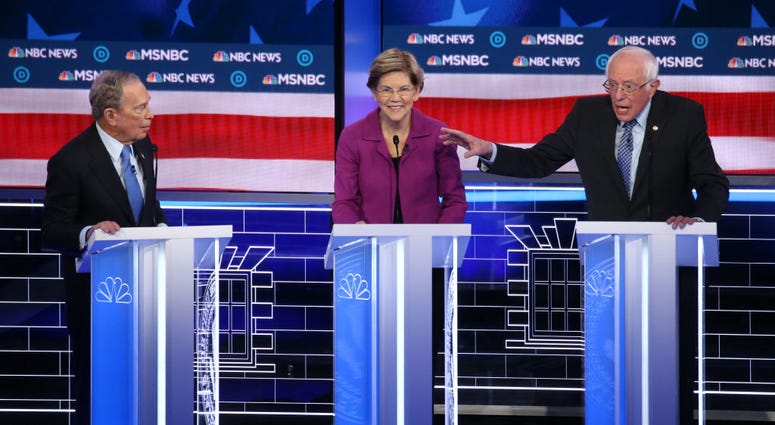 Democratic presidential candidates former New York City mayor Mike Bloomberg (L), and Sen. Elizabeth Warren (D-MA) listen as Sen. Bernie Sanders (I-VT) makes a point during the Democratic presidential primary debate at Paris Las Vegas on February 19, 2020