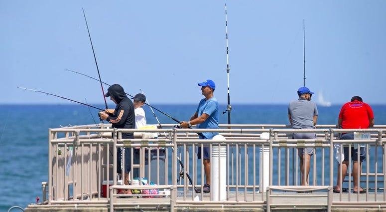 People fishing at the Newport Fishing Pier in Sunny Isles Beach as the coronavirus pandemic continues on Sunday, Sept. 6, 2020.