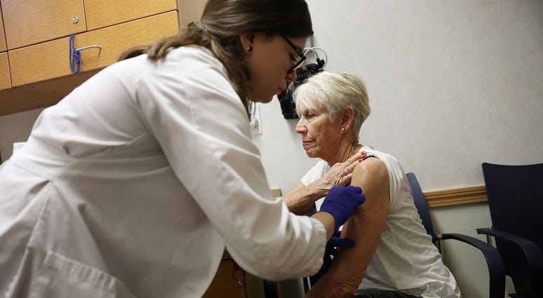 Luanne Boiko receives an influenza vaccination from nurse practitioner, Leslie Suarez, at the CVS Pharmacy store's MinuteClinic on October 4, 2018 in Miami, Florida.