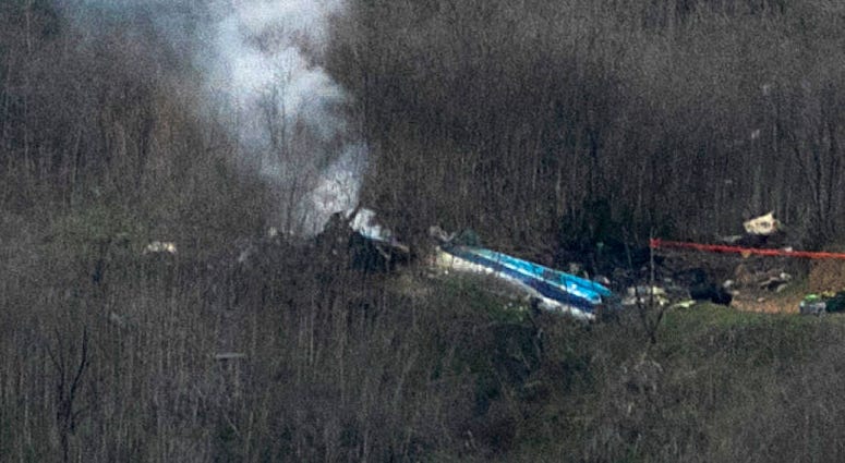 Wreckage of the crashed helicopter that was carrying former NBA star Kobe Bryant and his 13-year-old daughter Gianna smolders on the ground on January 26, 2020 in Calabasas, California.