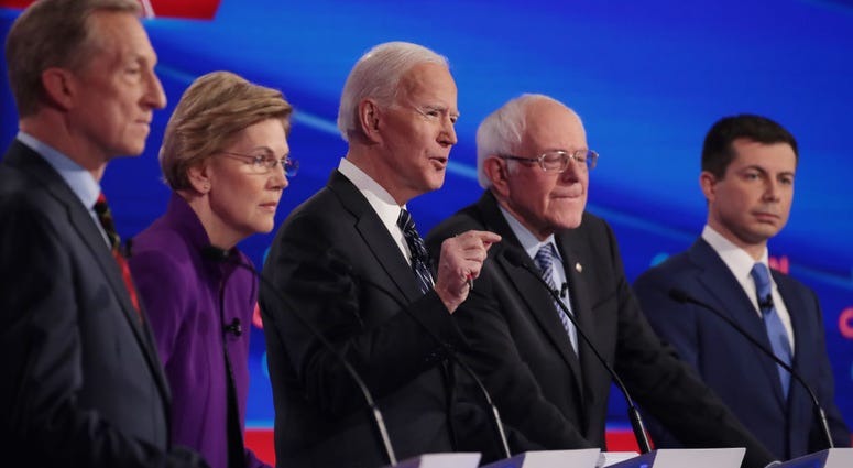 Tom Steyer (L), Sen. Elizabeth Warren (D-MA), Sen. Bernie Sanders (I-VT) and former South Bend, Indiana Mayor Pete Buttigieg (R) listen as former Vice President Joe Biden (C) speaks during the Democratic presidential primary debate at Drake University.
