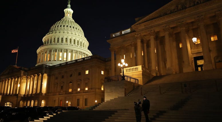 A reporter and camera operator work on the Senate steps during the first evening of President Donald Trump's impeachment trial January 21, 2020 in Washington, DC.