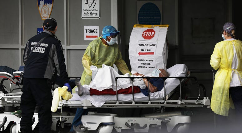 Medical workers take in patients at a special coronavirus intake area at Maimonides Medical Center on April 07, 2020 in the Borough Park neighborhood of the Brooklyn borough of New York City.