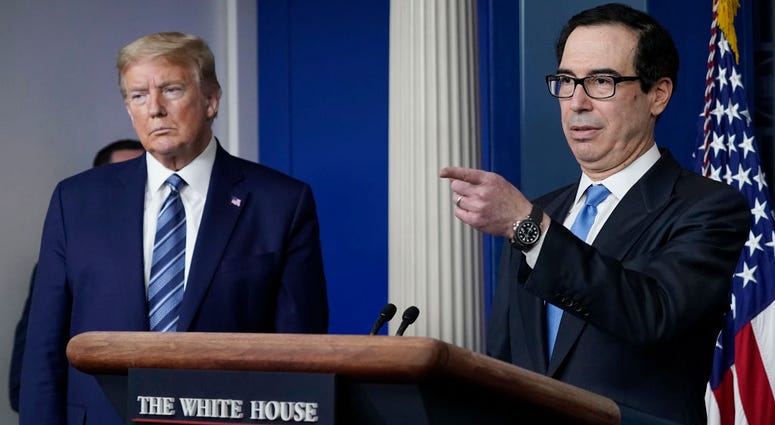 Treasury Secretary Steven Mnuchin speaks as U.S. President Donald Trump looks on during the daily coronavirus task force briefing at the White House on April 21, 2020 in Washington, DC.
