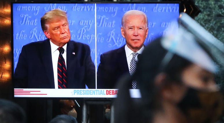 People sit to watch a broadcast of the first debate between President Donald Trump and Democratic presidential nominee Joe Biden on Tuesday, September 29, 2020.
