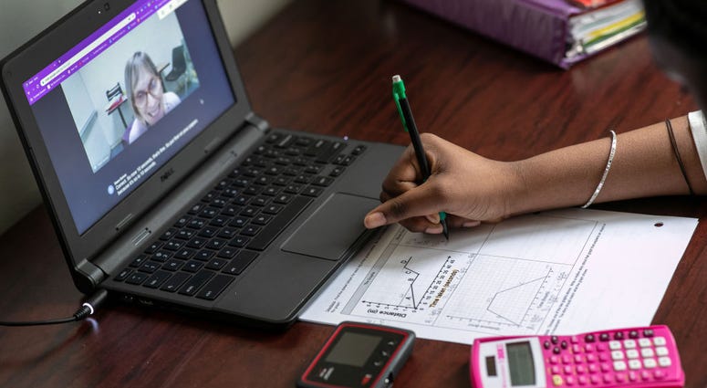 Abigail Previlon, 13, takes part in remote distance learning with her teacher Diane Gamse