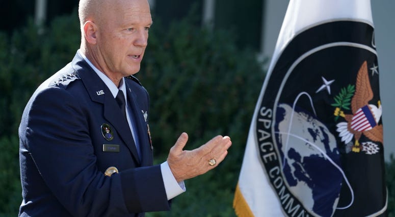 U.S. Air Force Space Command Gen. John "Jay" Raymond stands next to the flag of the newly established U.S. Space Command, the sixth national armed service, in the Rose Garden at the White House August 29, 2019 in Washington, DC.
