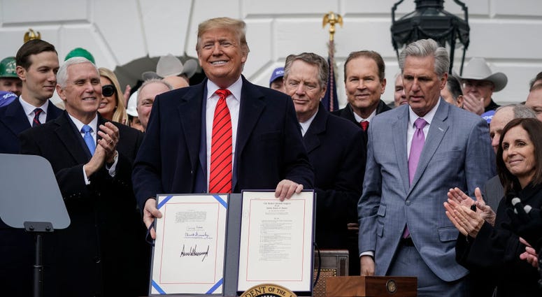 U.S. President Donald Trump stands after signing the United States-Mexico-Canada Trade Agreement (USMCA) during a ceremony on the South Lawn of the White House on January 29, 2020 in Washington, DC.