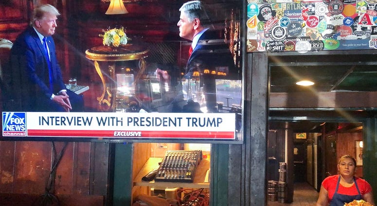 President Donald Trump’s pre-game Super Bowl interview with Fox News host Sean Hannity is broadcast in a bar on February 2, 2020 in Washington, DC.
