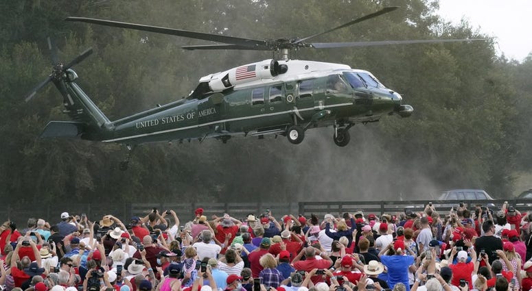 resident Donald Trump arrives in the Marine One helicopter at a campaign rally as supporters cheer Friday, Oct. 23, 2020, in The Villages, Fla.