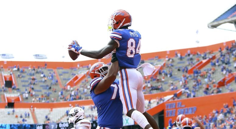 Florida tight end Kyle Pits (84) leaps up as he celebrates a touchdown catch with teammates during an NCAA college football game against South Carolina in Gainesville, Fla., Saturday, Oct. 3, 2020.