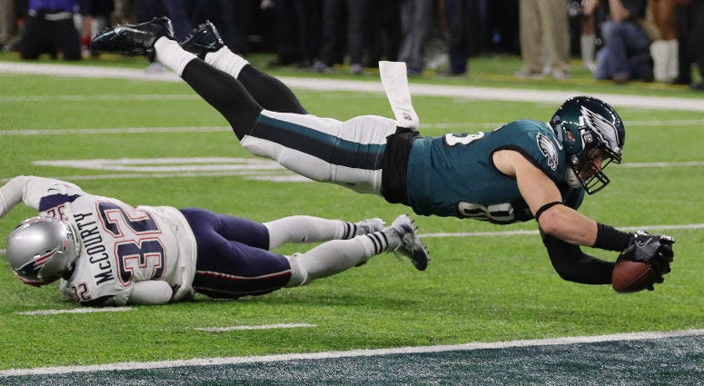 Philadelphia Eagles tight end Zach Ertz (86) dives over New England Patriots free safety Devin McCourty (32) to score game-winning touchdown in the fourth quarter in Super Bowl LII