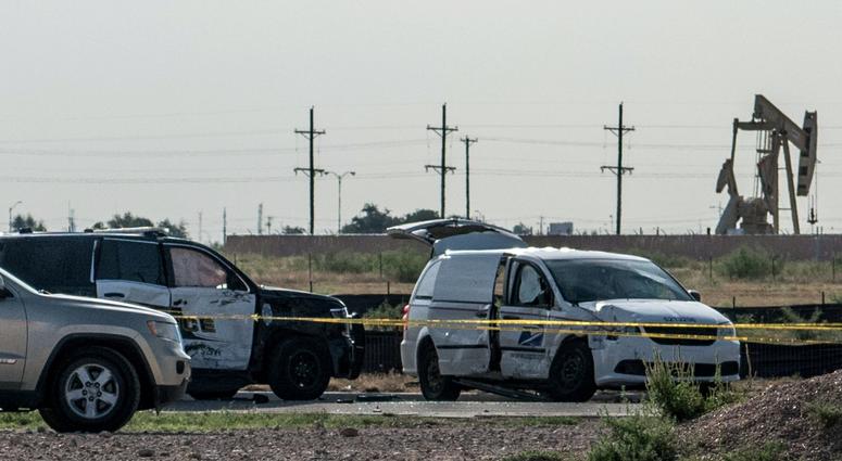 A damaged police vehicle and U.S. Postal Service van blocked off with tape nearby to where a gunman was shot and killed at Cinergy Odessa movie theater following a deadly shooting spree on September 1, 2019 in Odessa, Texas.