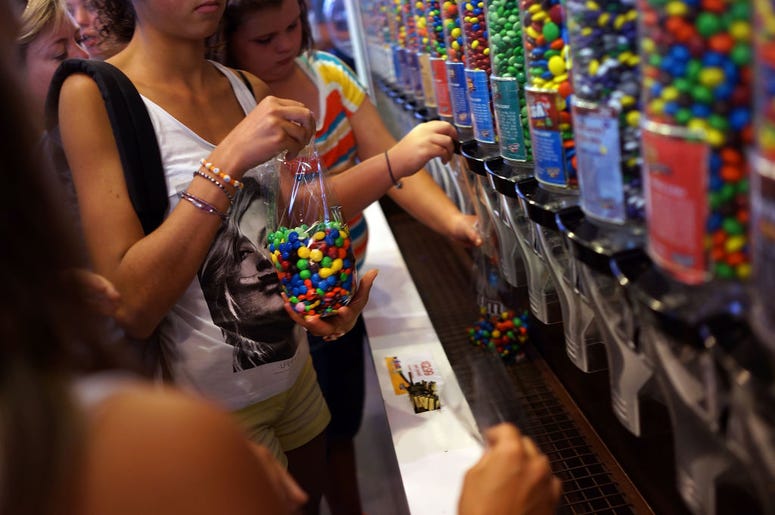 People fill up bags of M&M's at the M&M store in Times Square on July 24, 2014 in New York City. With the increase in cocoa prices, Mars Chocolate North America, the maker of Snickers and M&M's, announced an average price increase of 7 percent this week f