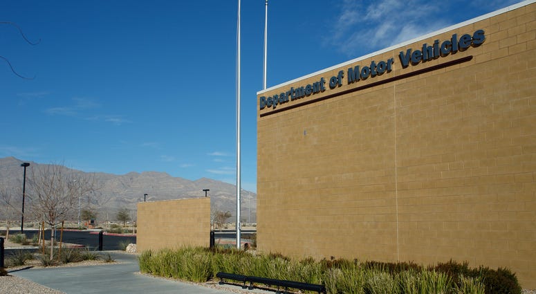 A bricked building with the words "Department of Motor Vehicles"