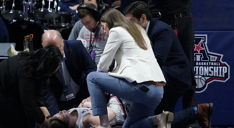 UConn Huskies forward Kyla Irwin (25) is looked after by medical staff after falling to the floor as they take on the South Florida Bulls in the second half of the American Conference Championship Semifinals at Mohegan Sun Arena. Mandatory Credit: David B
