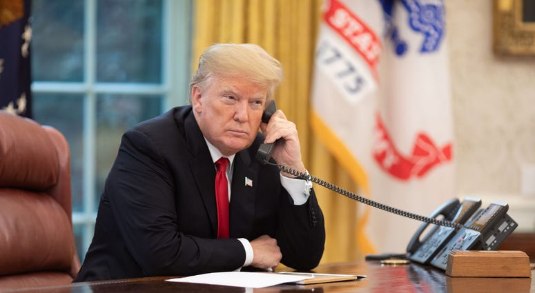 President Donald J. Trump speaks on the phone in the Oval Office